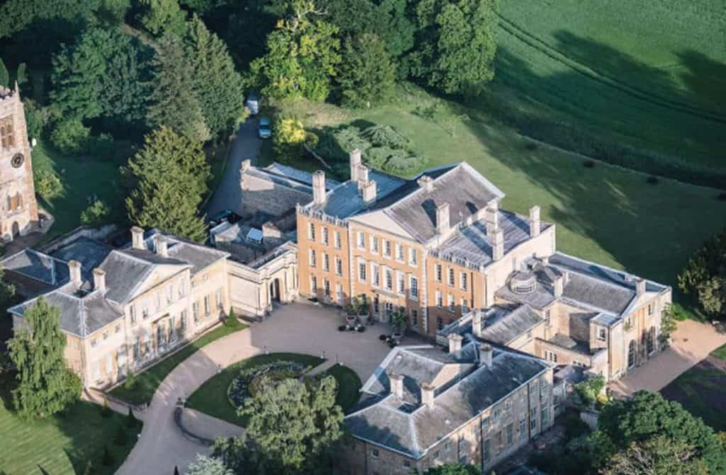 The splendid Aynhoe Park manor, set amid beautifully landscaped gardens, offering guests a magical retreat steeped in the rich history and elegance of the U.K.
