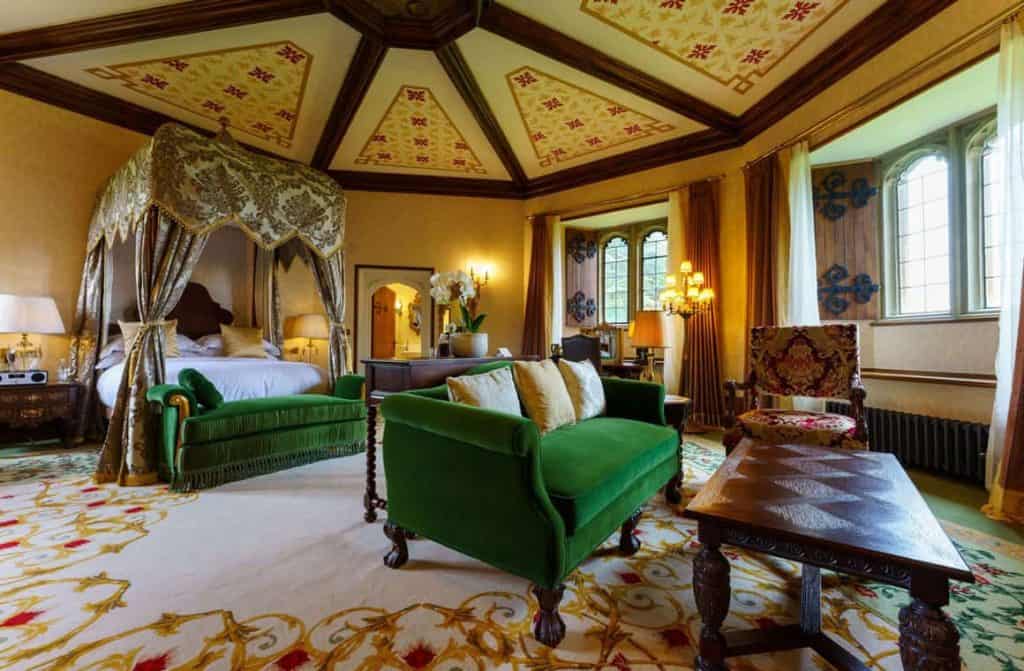 An elegantly appointed room in Thornbury Castle, featuring lavish décor, a four-poster bed, and opulent furnishings, offering a truly royal experience in the heart of the U.K.