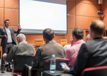 A meeting being held in a hotel conference room featuring state-of -the-art amenities
