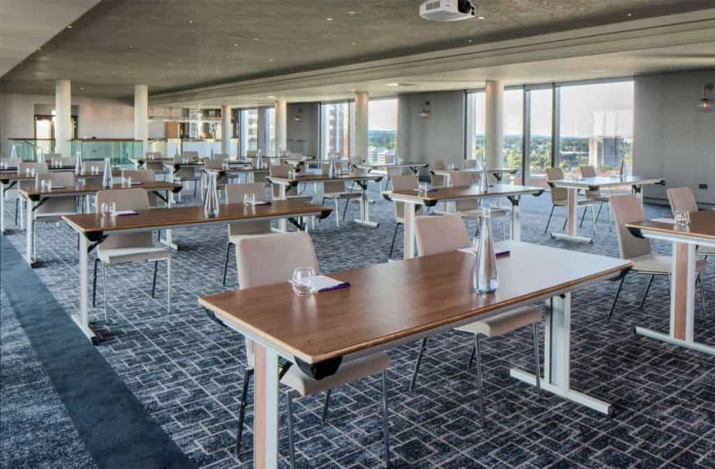 Spacious and modern conference suite at The Park Regis hotel Birmingham, with state-of-the-art technology and comfortable seating for productive meetings and events being featured in the article, "10 Best Business Hotels with Conference Facilities in Birmingham"