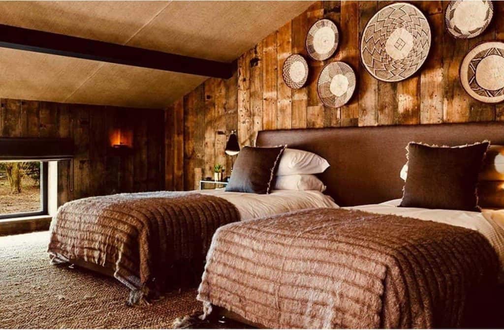 Cozy and well-appointed living space inside a Port Lympne treehouse, featuring comfortable seating, warm lighting, and tasteful décor.