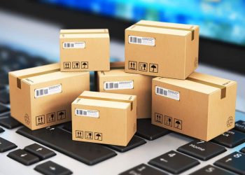 Boxes of various sizes and shapes stacked on top of each other, ready for shipping.