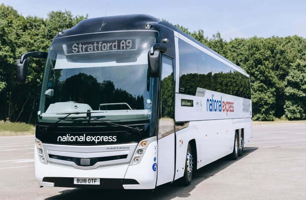 A National Express coach parked at a stop, offering budget-friendly airport transfers throughout the UK.