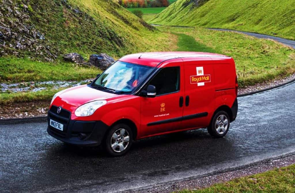 Royal Mail delivery van with packages and logo.