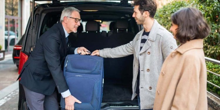 An airport transfer shuttle bus ready to pick up passengers, offering a budget-conscious option for UK travelers.