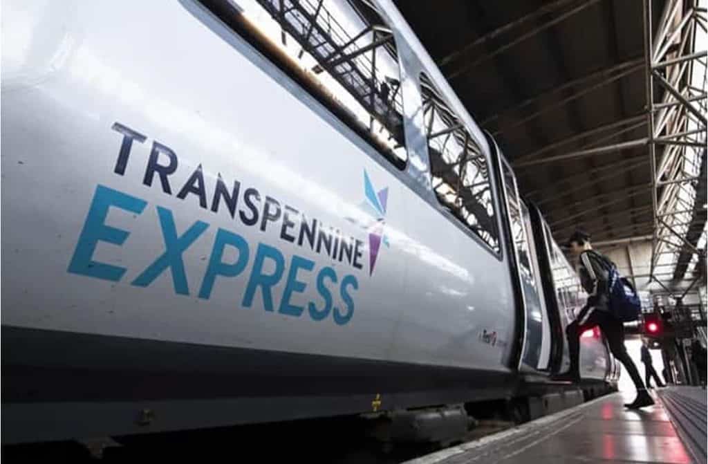 A TransPennine Express train on the tracks, offering budget-conscious passengers a reliable airport transfer solution in the UK.