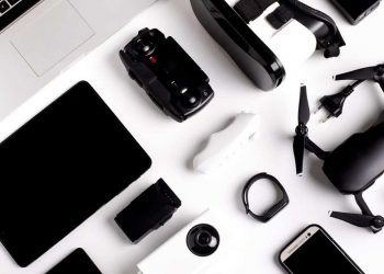 A variety of essential business travel gadgets neatly organised on a table