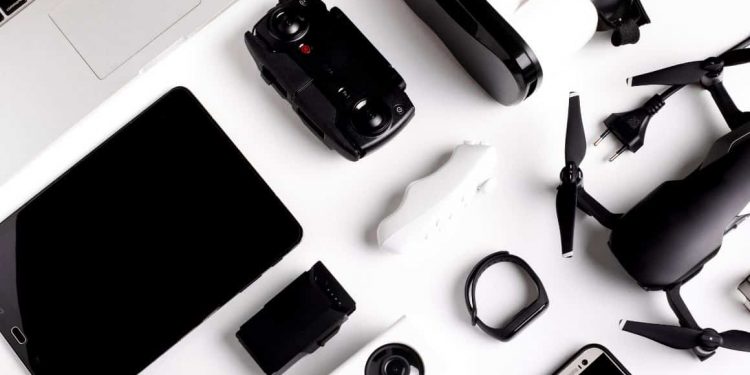 A variety of essential business travel gadgets neatly organised on a table