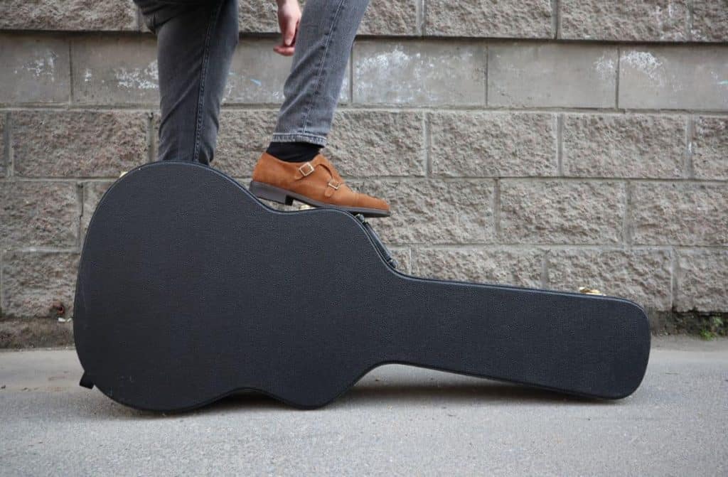 A guitar in a hard-shell case, an example of a special item that may be subject to different checked baggage size and weight restrictions by airlines in 2023.