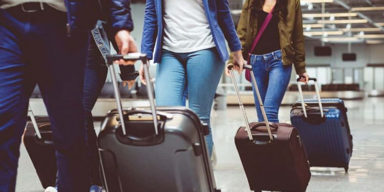 Suitcases lined up at the airport, ready for stress-free journeys