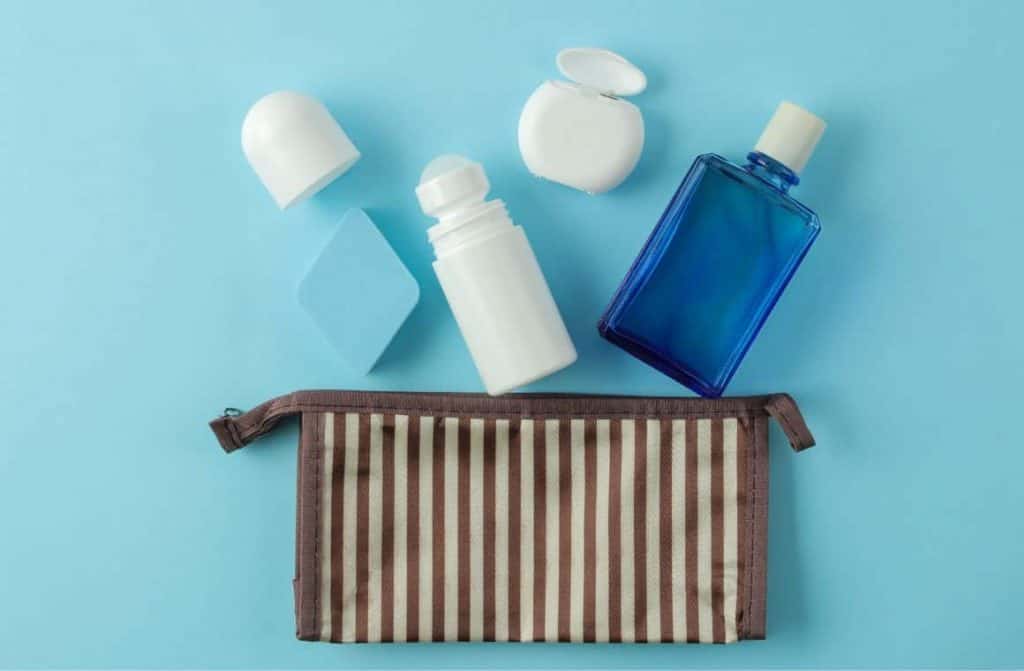 An assortment of travel-size toiletries in a clear zip bag.