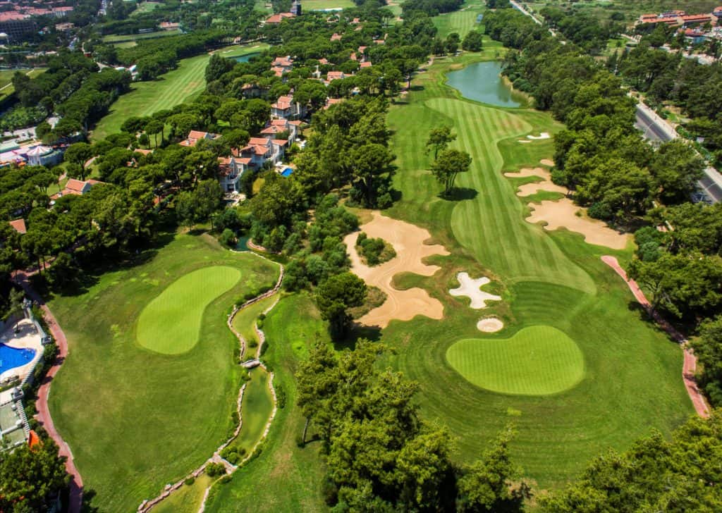 This image captures the stunning Maxx Royal Belek Golf Resort, a harmonious blend of luxury and sporting excellence in Turkey. The resort is set against a backdrop of lush, impeccably maintained golf greens, highlighting its reputation as a premier golf destination.