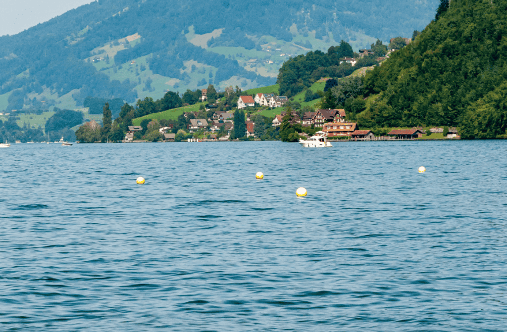 Breathtaking view of Lake of the Four Cantons in Switzerland, showcasing crystal-clear waters and Alpine scenery.