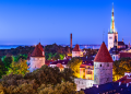 Picturesque view of Tallinn, Estonia, showcasing its medieval old town with cobblestone streets, historic buildings, and the iconic Tallinn Town Hall in the foreground.