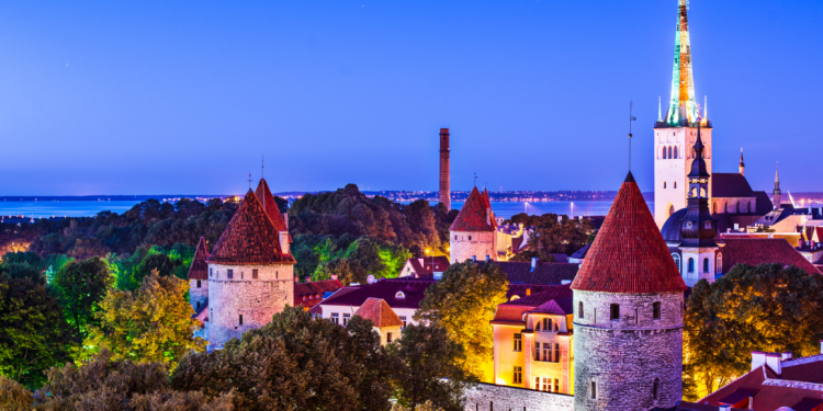 Picturesque view of Tallinn, Estonia, showcasing its medieval old town with cobblestone streets, historic buildings, and the iconic Tallinn Town Hall in the foreground.