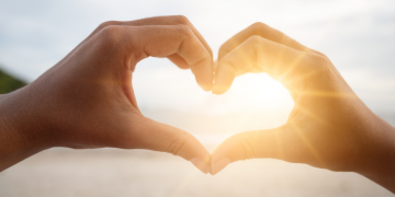 Two hands forming a heart shape, symbolising love and connection.